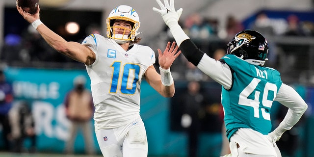 Los Angeles Chargers quarterback Justin Herbert throws a pass against the Jacksonville Jaguars during the first half of a wild-card playoff game, Saturday, Jan. 14, 2023, in Jacksonville, Florida.