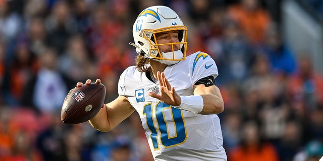 Los Angeles Chargers quarterback Justin Herbert (10) sets to pass in the first quarter during a game between the Los Angeles Chargers and the Denver Broncos at Empower Field at Mile High on January 8, 2023, in Denver, Colorado.