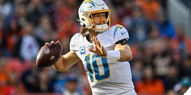 Los Angeles Chargers quarterback Justin Herbert (10) sets to pass in the first quarter during a game between the Los Angeles Chargers and the Denver Broncos at Empower Field at Mile High on January 8, 2023, in Denver, Colorado.