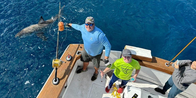 12-year-old Campbell Keenan and his family with the great white shark