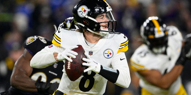 Pittsburgh Steelers quarterback Kenny Pickett (8) throws against the Baltimore Ravens in the first half of an NFL football game in Baltimore, Sunday, Jan. 1, 2023. 