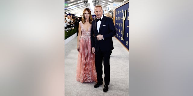 Christine Baumgartner and Kevin Costner attend the 28th Annual Screen Actors Guild Awards at Barker Hangar on February 27, 2022 in Santa Monica.