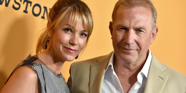 Kevin Costner and his wife on red carpet