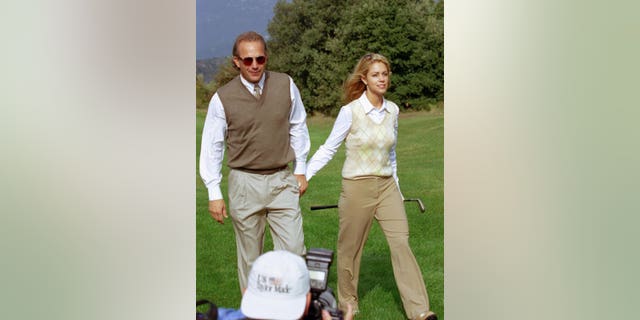 Kevin Costner and Christine during a golf tournament