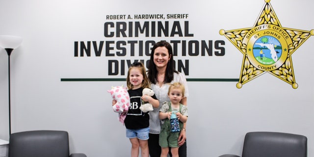 Kirsten Bridegan poses with her daughters Bexley and London, who are standing on a Bexley Box at the St. Johns County Sheriff's Office. 