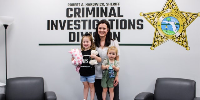 Kirsten Bridegan poses with her daughters Bexley and London, who are standing on a Bexley Box at the St. Johns County Sheriff's Office. 