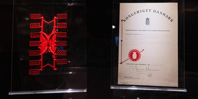 Early LEGO bricks are displayed next to a patent certificate at the LEGO Museum in Billund, Denmark.