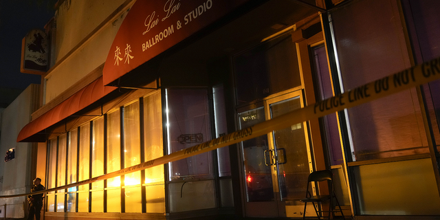 A police officer stands outside Lai Lai Ballroom and Studio in Alhambra, California, on Sunday, Jan. 22.