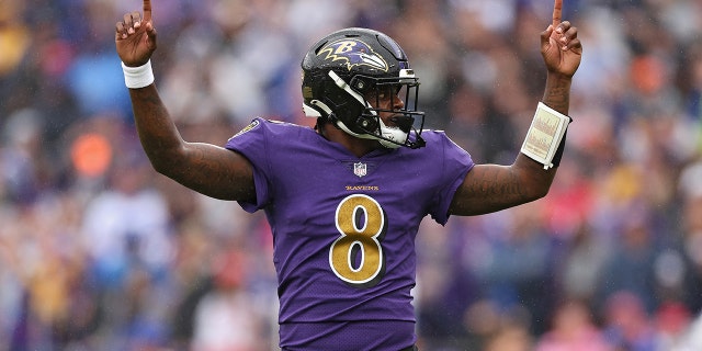 Baltimore Ravens quarterback Lamar Jackson #8 celebrates after teammate JK Dobbins #27 scored a touchdown in the first quarter against the Buffalo Bills at M&T Bank Stadium on October 2, 2022 in Baltimore, Maryland .