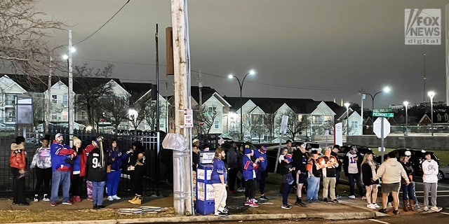Fans gather outside University of Cincinnati Medical Center and pray for 24-year-old Buffalo Bills player Damar Hamlin. 