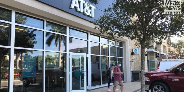 Christopher and Roberta Laundrie leave a Florida AT&amp;T store on Oct. 19, 2021.