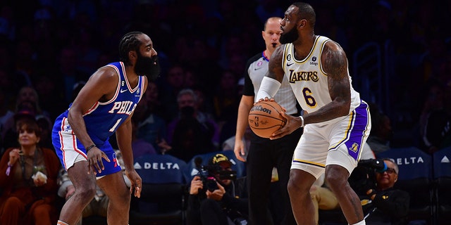 January 15, 2023;  Los Angeles, California, United States;  Los Angeles Lakers forward LeBron James (6) controls the ball against Philadelphia 76ers guard James Harden (1) during the first half at Crypto.com Arena.