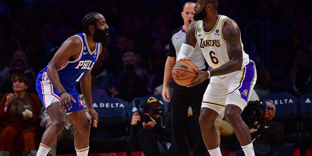 January 15, 2023;  Los Angeles, California, United States;  Los Angeles Lakers forward LeBron James (6) controls the ball against Philadelphia 76ers guard James Harden (1) during the first half at Crypto.com Arena.