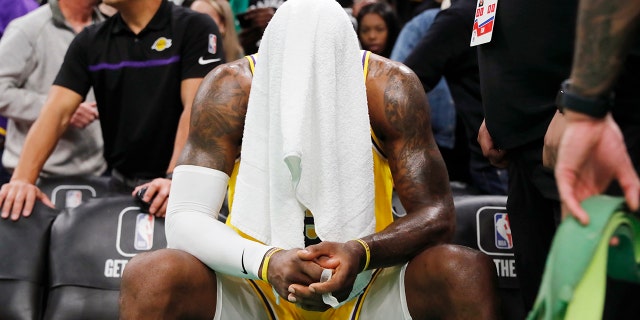 LeBron James of the Los Angeles Lakers sits on the bench during overtime during the team's NBA basketball game against the Boston Celtics, Saturday, Jan. 28, 2023, in Boston. 