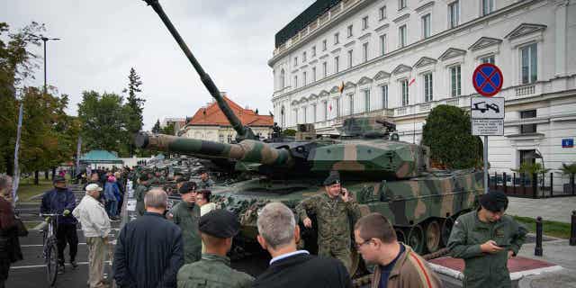 A Leopard 2 tank of the Polish Army is seen with a soldier in camouflage near Pilsudski Square in Warsaw, Poland on 13 September, 2022. (Photo by STR/NurPhoto via Getty Images)