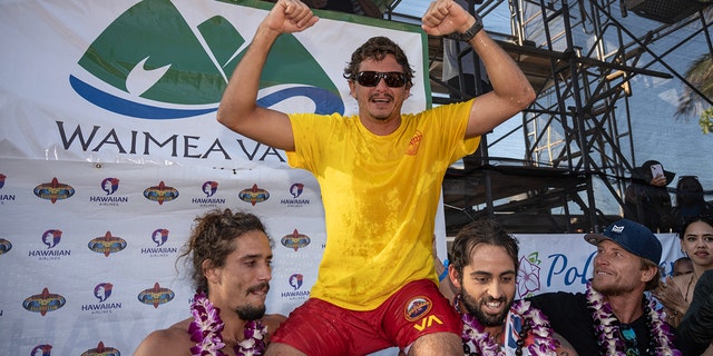 On duty lifeguard Luke Shepardson celebrates winning the Eddie Ekau Big Wave Invitational on January 22, 2023 in Waimea Bay, Haleiwa, Hawaii.