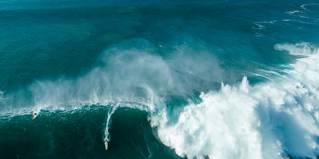 An overhead view of local lifeguard Luke Shepardson riding a giant wave en route to his victory during the Eddie Aikau Big Wave Invitational on January 22, 2023 in Waimea Bay, Haleiwa, Hawaii.