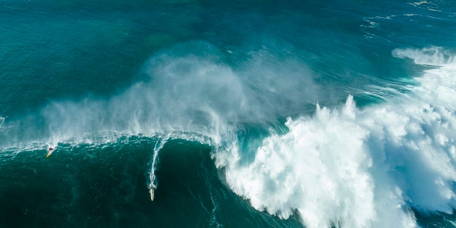 An aerial view of local lifeguard Luke Shepardson riding a giant wave en route to his win during the Eddie Aikau Big Wave Invitational on Jan. 22, 2023 in Waimea Bay, Haleiwa, Hawaii.