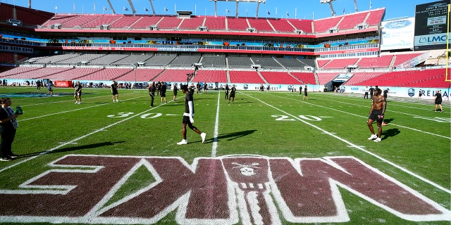 Mississippi State players warm up in front of the painting "microphone" – Former head coach Mike Leach – Monday, January 2, 2023, before the ReliaQuest Bowl against Illinois in Tampa, Florida.