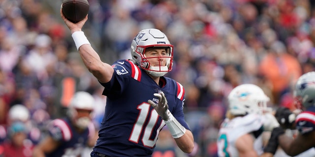 New England Patriots quarterback Mac Jones throws against the Miami Dolphins, Sunday, Jan. 1, 2023, in Foxborough, Massachusetts.