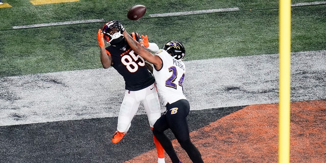 Baltimore Ravens cornerback Marcus Peters (24) breaks up a pass intended for Cincinnati Bengals wide receiver Tee Higgins (85) in the first half of an NFL wild-card playoff football game in Cincinnati, Sunday, Jan. 15, 2023.
