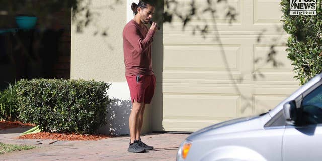 Mario Fernandez is seen trimming his beard outside of his home in Kissimmee, Florida, Friday, January 23, 2023. Fernandez is a suspect in the murder of Jared Bridegan.