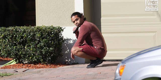 Mario Fernandez is seen trimming his beard outside of his home in Kissimmee, Florida, Friday, January 23, 2023. Fernandez is a suspect in the murder of Jared Bridegan.