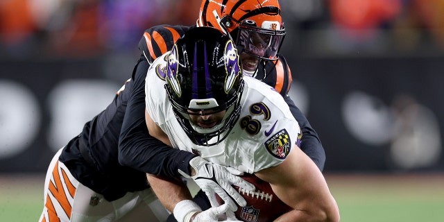 Bengals' Eli Apple tackles Baltimore Ravens' Mark Andrews at Baycore Stadium on January 15, 2023 in Cincinnati.