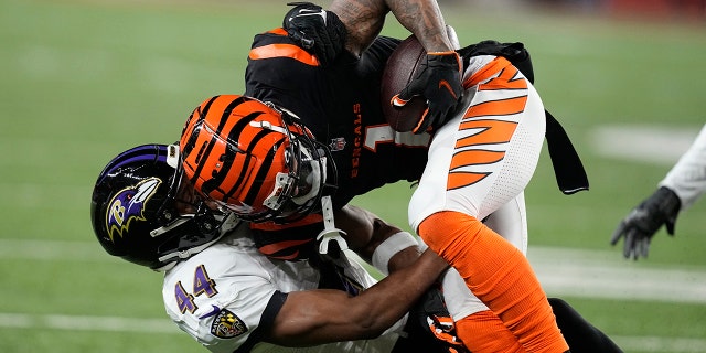 Bengals wide receiver Ja'Marr Chase is tackled by Baltimore Ravens cornerback Marlon Humphrey during the wild-card playoff game in Cincinnati, Sunday, Jan. 15, 2023.