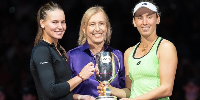 Martina Navratilova, Elise Mertens and Veronika Kudermetova pose with the trophy during the WTA Finals at Dickies Arena on Nov. 7, 2022, in Forth Worth, Texas.