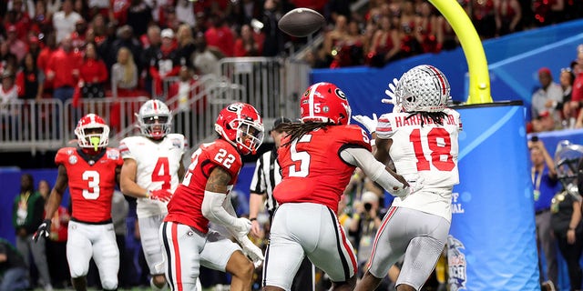 Marvin Harrison Jr. (18) of the Ohio State Buckeyes attempts to catch a pass during the third quarter against the Georgia Bulldogs at the Chick-fil-A Peach Bowl at Mercedes-Benz Stadium on December 31, 2022 in Atlanta. 