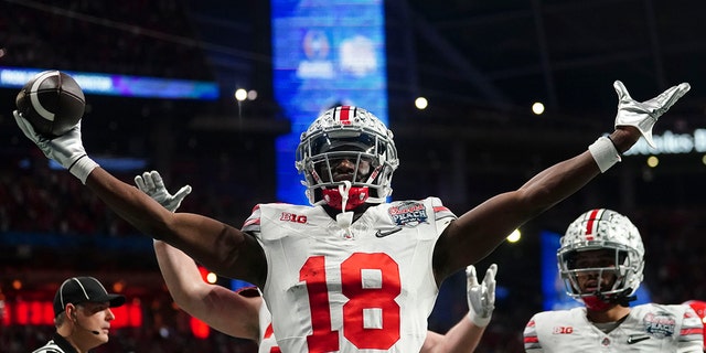 Ohio State wide receiver Marvin Harrison Jr. celebrates his touchdown catch against Georgia during the first half of the Peach Bowl on December 31, 2022 in Atlanta. 