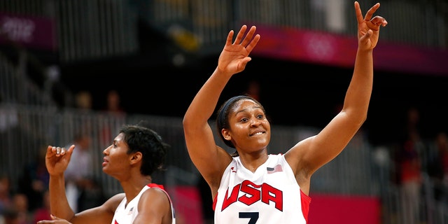 Maya Moore (7) and Angel McCoughtry (8) both of the USA wave to the crowd after defeating Canada in the women's basketball quarterfinal match at the Basketball Arena, London during the London 2012 Olympic Games on August 7, 2012.