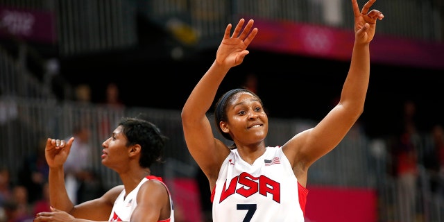 Maya Moore (7) and Angel McCoughtry (8) both of the USA wave to the crowd after defeating Canada in the women's basketball quarterfinal match at the Basketball Arena, London during the London 2012 Olympic Games on August 7, 2012.