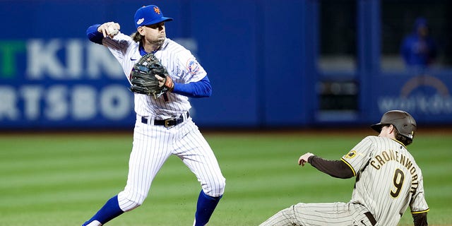 Jeff McNeil of the New York Mets attempts to convert a double play against the San Diego Padres during the fourth inning of game two of the Wild Card Series at Citi Field in New York City on October 8, 2022.