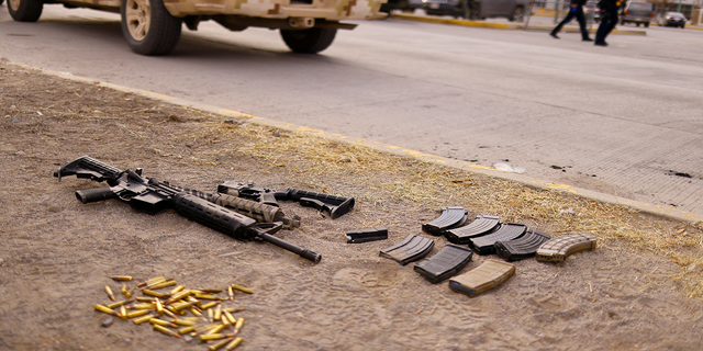 Guns and bullets are seen outside the prison in Ciudad Juarez on Sunday.
