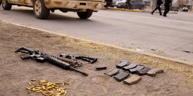 Guns and bullets are seen outside the prison in Ciudad Juarez on Sunday.