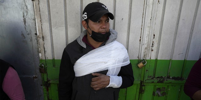 A subway passenger, injured when two subway trains collided, waits to be taken to a hospital, in Mexico City, Saturday, Jan. 7, 2023.