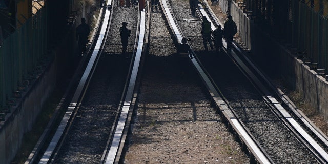 Rescue workers inspect rail lines after two subway trains collided, in Mexico City, Saturday, Jan. 7, 2023. Authorities announced at least one person was killed and dozens were injured in the Saturday accident on Line 3 of the capital's subway. 