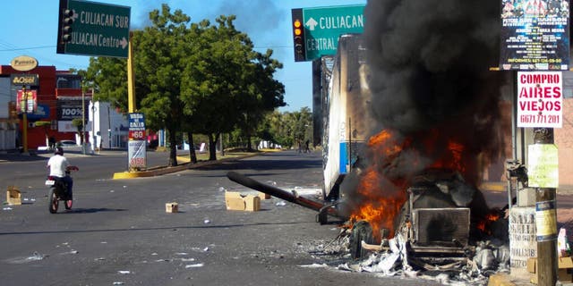 A truck burns after being set on fire on a street in Culiacan, Sinaloa state, Mexico, on Thursday. Mexican security forces captured Ovidio Guzmán, an alleged drug trafficker wanted by the U.S. and one of the sons of former Sinaloa cartel boss Joaquín "El Chapo" Guzmán, in a pre-dawn operation that set off gunfights and roadblocks across the western state’s capital.