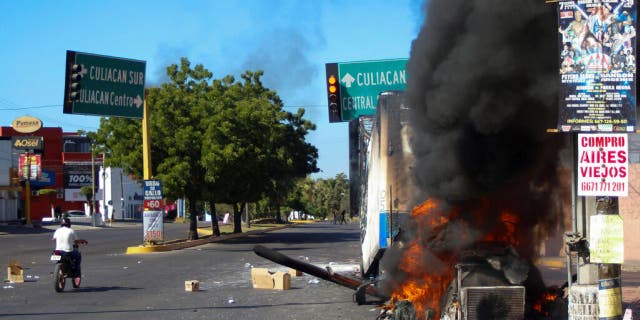 A truck burns after being set on fire on a street in Culiacan, Sinaloa state, Mexico, on Thursday. Mexican security forces captured Ovidio Guzmán, an alleged drug trafficker wanted by the U.S. and one of the sons of former Sinaloa cartel boss Joaquín "El Chapo" Guzmán, in a pre-dawn operation that set off gunfights and roadblocks across the western state’s capital.