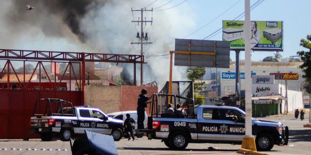 The police arrives on the scene after a store was looted in Culiacan, Sinaloa state, Thursday, Jan. 5, 2023. 