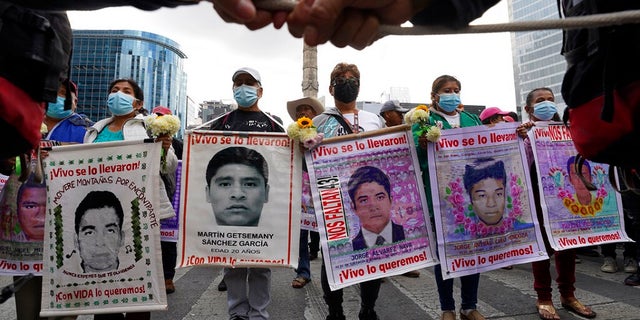 Relatives and classmates of the missing 43 Ayotzinapa college students, march in Mexico City, Sept. 26, 2022, on the anniversary of their disappearance in Iguala, Guerrero state. U.S. authorities handed over a key suspect, Alejandro Tenescalco, in the 2014 disappearances, after the man was caught trying to cross the border Dec. 20, 2022 without proper documents. 