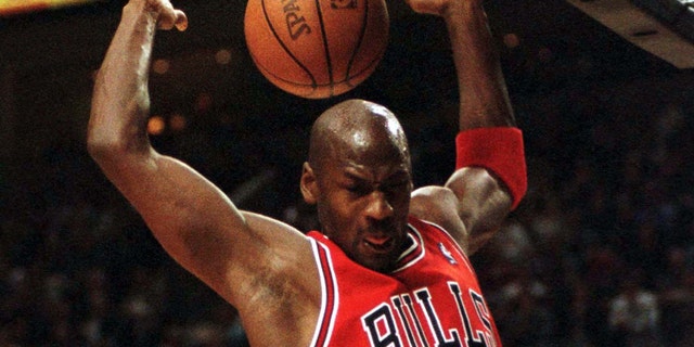 Michael Jordan of the Chicago Bulls finishes a slam dunk against the Trail Blazers at the Portland Rose Garden.
