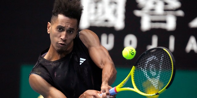Michael Mmoh plays a backhand return to Alexander Zverev at the Australian Open in Melbourne on Thursday, January 19, 2023.