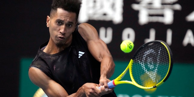 Michael Mmoh plays a backhand return to Alexander Zverev at the Australian Open in Melbourne on Thursday, January 19, 2023.