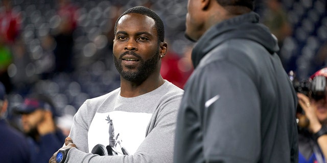 Michael Vick looks on from the side before an NFL football game between the Houston Texans and the New England Patriots on Sunday, December 1, 2019.