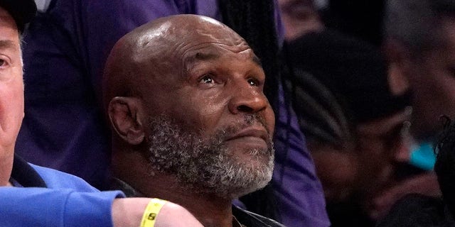 Mike Tyson watches the first half of an NBA game