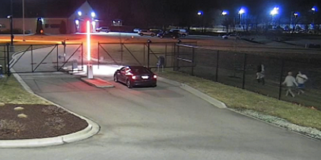 The other three inmates are seen making their way toward the stolen vehicle in Farmington, Missouri.