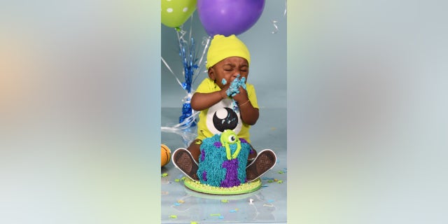 Amandi takes a bite of birthday cake months after he left the NICU.